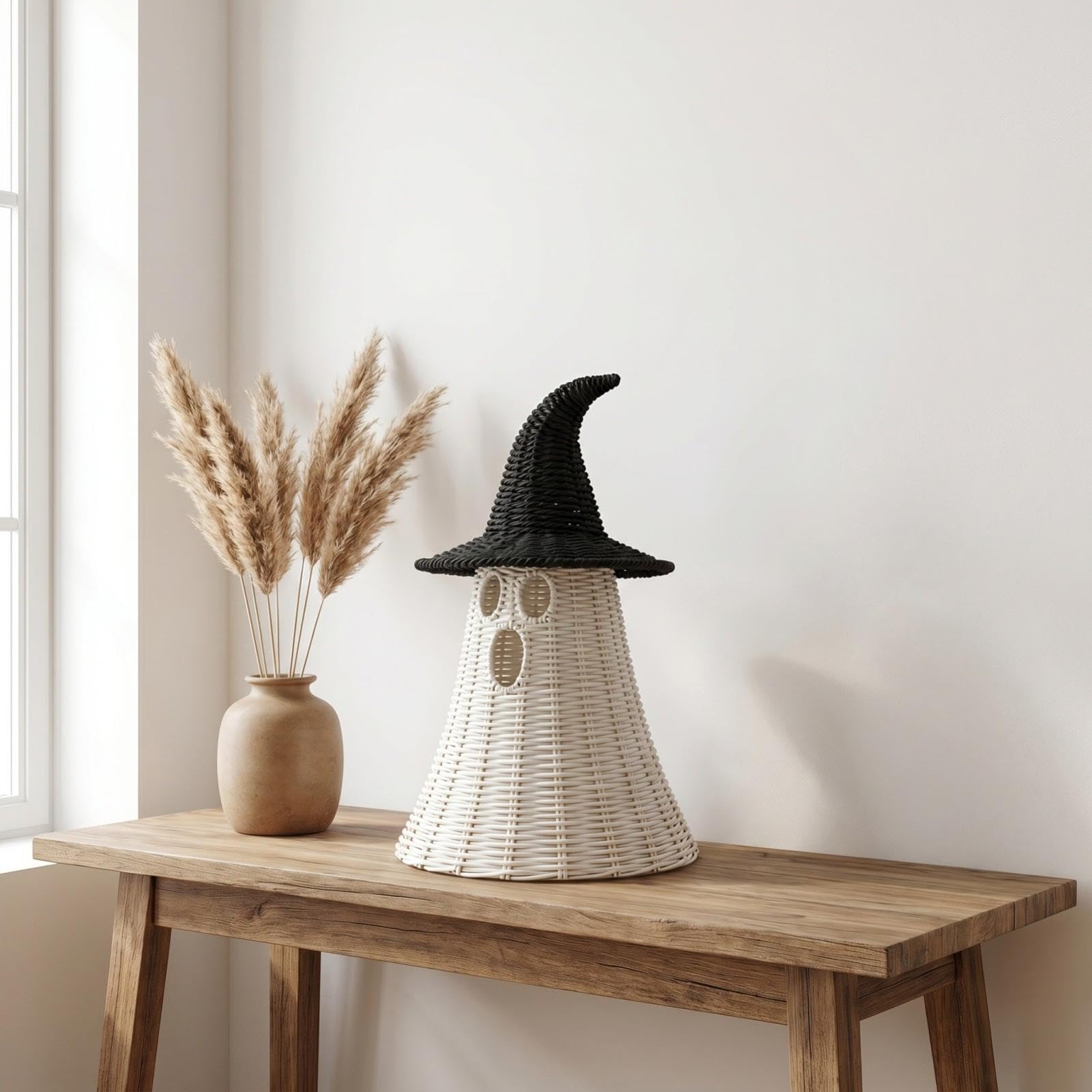 Handwoven natural-look ghost with black witch hat table decor
